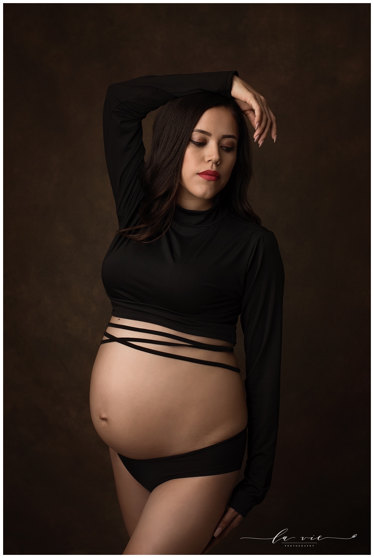 Fashion oriented maternity portrait with black wrap crop top